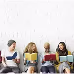 people sitting together reading a book