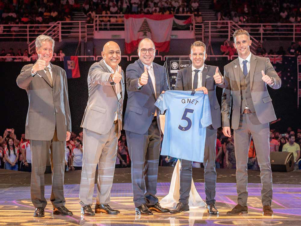 qnet on stage with manchester united