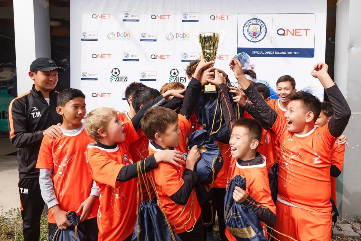 Children celebrating with golden trophy