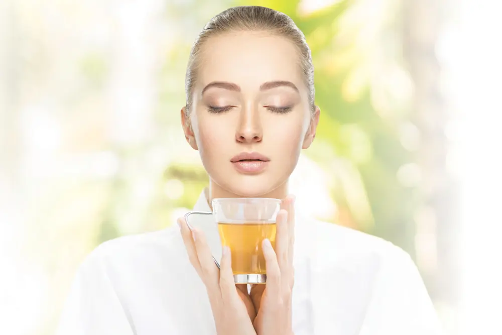 Four Healthy Habits For A Slimmer You 3 Woman holding belite tea cup in white robe