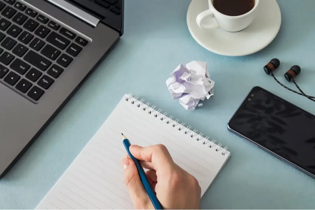 Top 5 New Year’s Resolutions For Business Success 4 Writing down new year's resolutions for direct sellers and business success over coffee