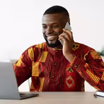 Man on phone smiling on QNET business call