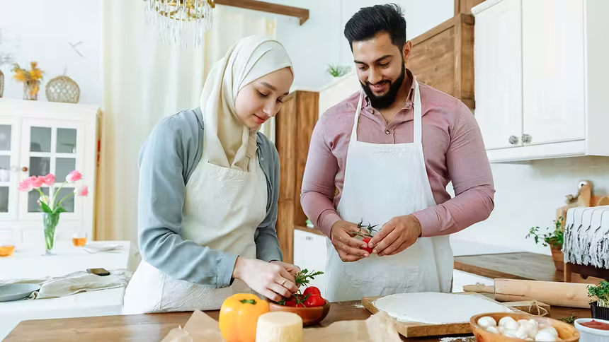 Man and woman preparing food for Ramadan