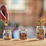 Mastering the 3 Ms of Money: Make, Manage, Multiply putting coins in a jar